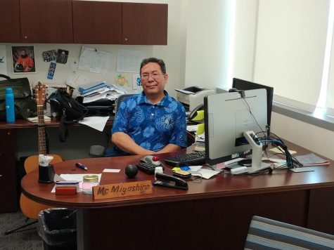 Ross Miyashiro sits at his desk next to his guitar on Oct. 5. Occasionally, he'll play while in his office. Miyashiro will retire on Jan. 1, 2023. (Anthony Lipari | The Union)
