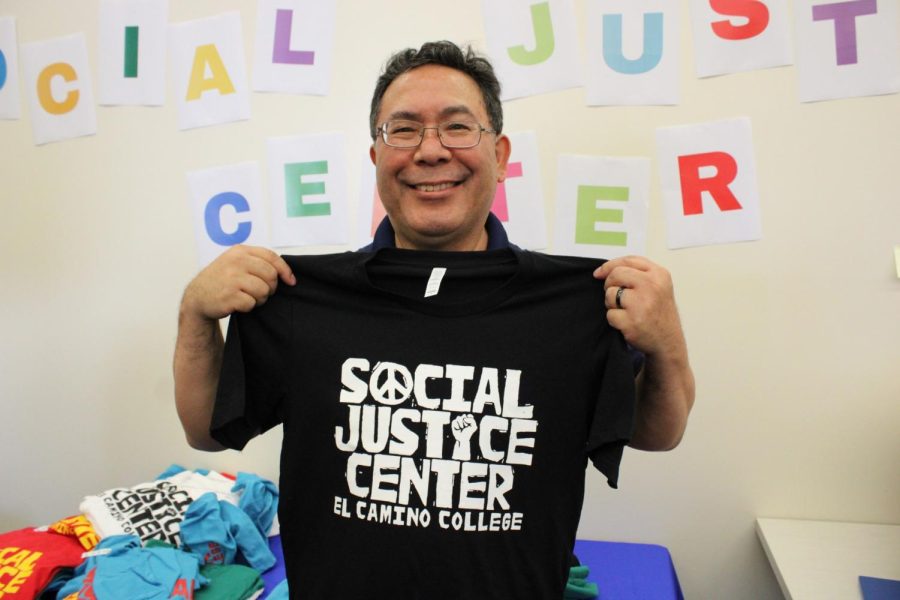 Vice President of Student Services Ross Miyashiro models a t shirt, the shirts were being given away during the grand opening of The Social Justice Center on Wed. Sept. 28. (Kim McGill | The Union)