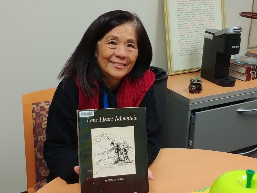 Assistant Director of the Learning Resources Center Sheryl Kunisaki holds Lone Heart Mountain by Estelle Ishigo. The book tells the story of her father-in-law Kenji Kunisaki having to go to Heart Mountain, one of the concentration camps on the West Coast during World War II. The book is on display and can be checked out at the Library. (Anthony Lipari | The Union)