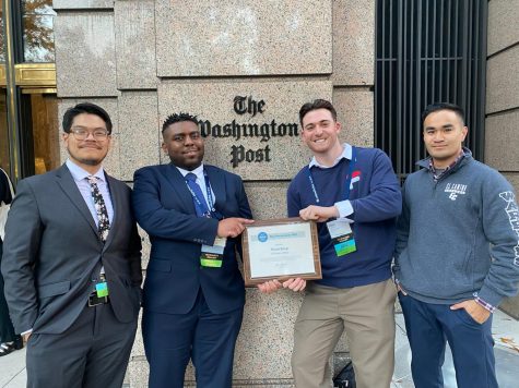 (From L-R) The Union editors Delfino Camacho, Khoury Williams, Ethan Cohen, and Greg Fontanilla stand in front of The Washington Post with the Associated Collegiate Press Pacemaker 100 Finalist award on Saturday, Oct. 29 in Washington, D.C. The publication was formerly known as Warwhoop before becoming The Union. (Photo courtesy of Stefanie Frith)
