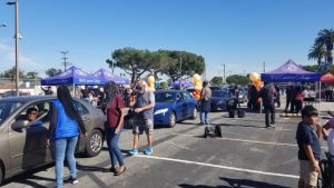 A line of cars drive through Lot B of the El Camino College campus waiting to receive meals from volunteers at the annual Drive-Through Food & Turkey Giveaway on Tuesday, Nov. 22. (Ricardo Arellanes | The Union)