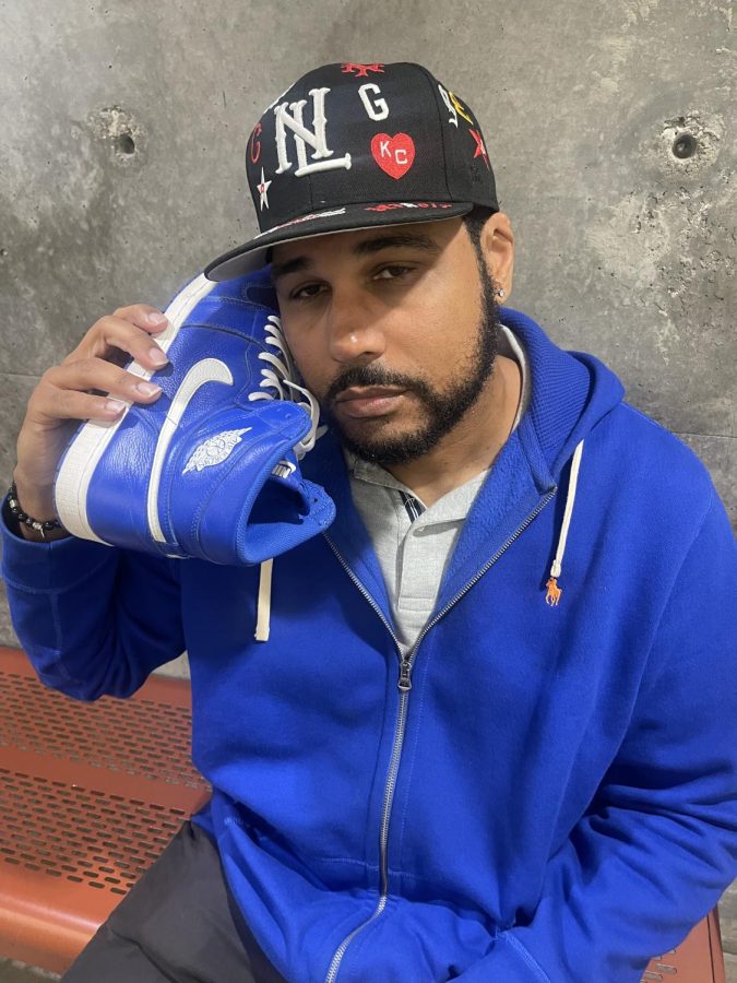 Sports and entertainment journalist Nick Hamilton poses with his blue sneakers that match his jacket. Hamilton was introduced to the sneaker culture when his father gave him his first pair of Jordans. I dont follow trends, I set trends, Hamilton said. (Khallid Muhsin | The Union)