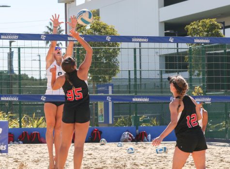 Warriors player Emily Uhrinak (left) jumps to block a spike from Eagles player Alicia Vasquez (center) during a match at the ECC Sand Courts on Friday, Jan. 27. Uhrinak spent the summer and fall training in order to compete on a higher level this season. (Ethan Cohen | The Union)