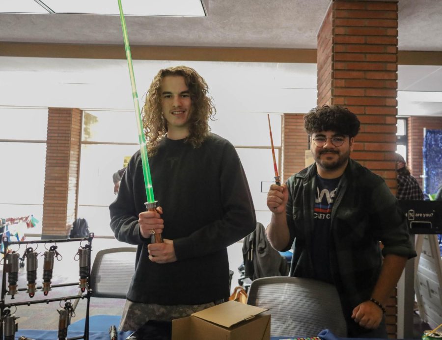 President of ECC3D Joseph Dean, left and club member Ernesto Renteria, right show lightsabers that have been made by 3D printing at their table during Club Rush on Monday, Feb. 27. Dean hopes to create a company based on the club as a way to help students get a career in computer-aided design. (Brianna Vaca | The Union)
