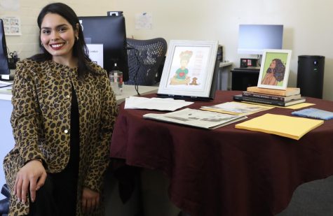 Dr. Cindy R. Escobedo, Ph.D., poses by a table containing books and artwork related to her research and education in the Social Justice Center on Wednesday, March 15. One of those books is a dissertation written by her mother, Cecilia Escobedo. (Greg Fontanilla | The Union)