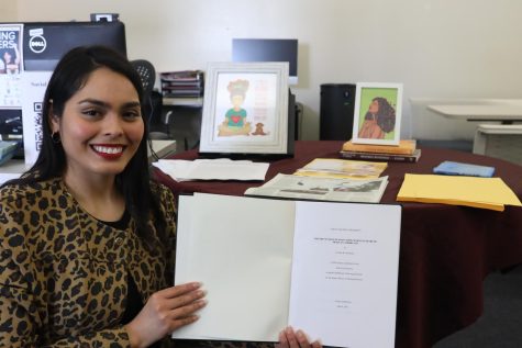 Dr. Cindy R. Escobedo, PhD, poses with a dissertation written by her mother, Cecilia Escobedo at the Social Justice Center on Wednesday, March 15. (Greg Fontanilla | The Union)