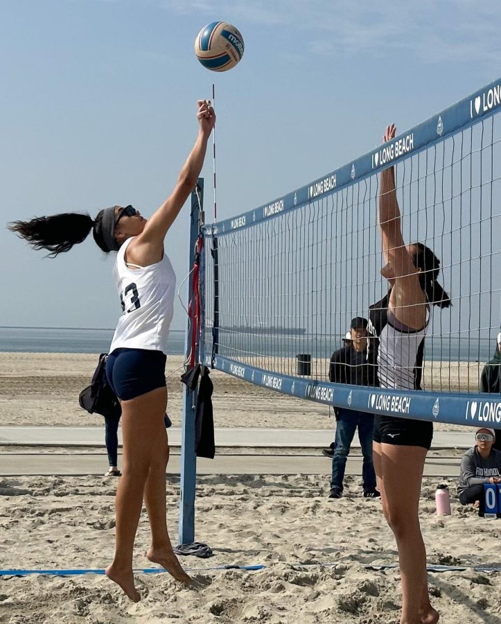 El Camino sophomore Leafa Juarez tips the ball over the net as Rio Hondo College sophomore Faith Wada (right) attempts to block during a March 17 conference matchup at Rosies Dog Beach in Long Beach. (Eddy Cermeno | The Union) Photo credit: Eddy Cermeno