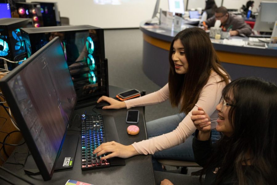 Sociology major Vianka Smith (back) and her friend Diana Ojeda (front) share laughs after getting spawn-killed over a fun and intense match playing Call of Duty: Modern Warfare 2 at the Warrior Esports Center on Feb. 27. Smith said that she doesnt have access to play video games at home, but she enjoys going to the center to play games for fun. (Khoury Williams | The Union)