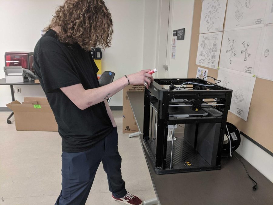 3D Printing Club President Joseph Dean inputs a program into his printer at Schauerman Librarys Makerspace on Tuesday, March 28. Dean founded the 3D Printing Club in Sept. 2022 as a way for him to share his passion for 3D printing with others. (Ari Martinez | The Union)