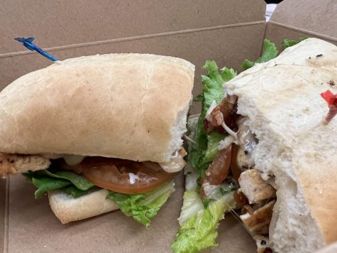 The Bacon Ranch sandwich from Café Camino costs $9.56 and has 901 calories. It comes with a well-marinated grilled chicken breast, bacon, and a slice of Provolone cheese melted into ciabatta bread.