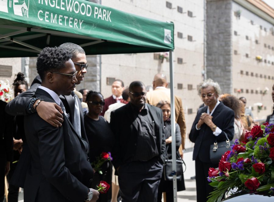 Kaleb (front) and Kenneth Brown II embrace each other before their father is entombed in the Garden of Chimes mausoleum at Inglewood Cemetary Park on April 11. Kenneth Brown is survived by his two sons, his wife Karla Brown and his mother Martha Brown. (Khoury Williams | The Union)