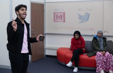 Muslim Student Association President Uzair Pasta explains the rules of the game "Mafia" to his peers in the Social Justice Center on April 5.