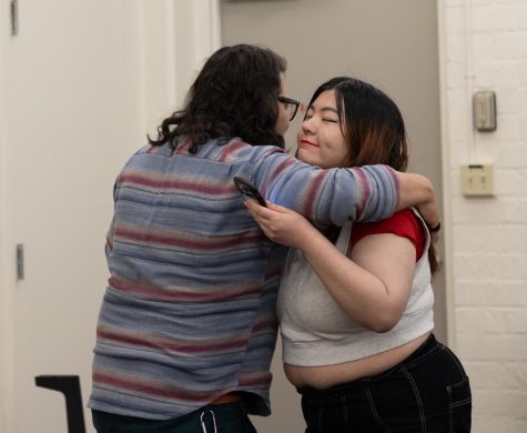 English major Mila Ishikawa-Gonzales give a hug to her instructor and event coordinator Shane Ochoa before performing her poem "Unbodied" on April 27. Ishikawa-Gonzales won first place and was the only poet to score a perfect 50 points from the judges. (Khoury Williams | The Union)
