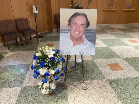 A picture of John Britton displayed inside American Martyrs Catholic Church in Manhattan Beach on May 6 for the service alongside blue and white flowers, the colors of Brittons native Scotland. (Joshua Flores | The Union)