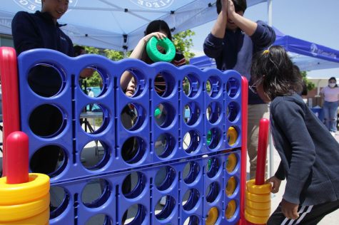 Children play a game on a giant Connect 4 playset at the Parent and Community Resource Fair at El Camino College on June 3. (Raphael Richardson | The Union)