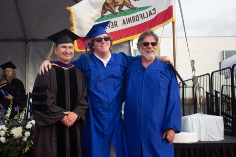 El Camino College stage manager Jerrold Root was working during the 2023 commencement ceremony that took place June 9. His son, Tyler Root was graduating that same day. Quickly donning a blue gown lent to him by the college Jerrold took a moment to celebrate and get a photo opportunity with his son and trustee Nilo Michelin. Delfino Camacho | The Union