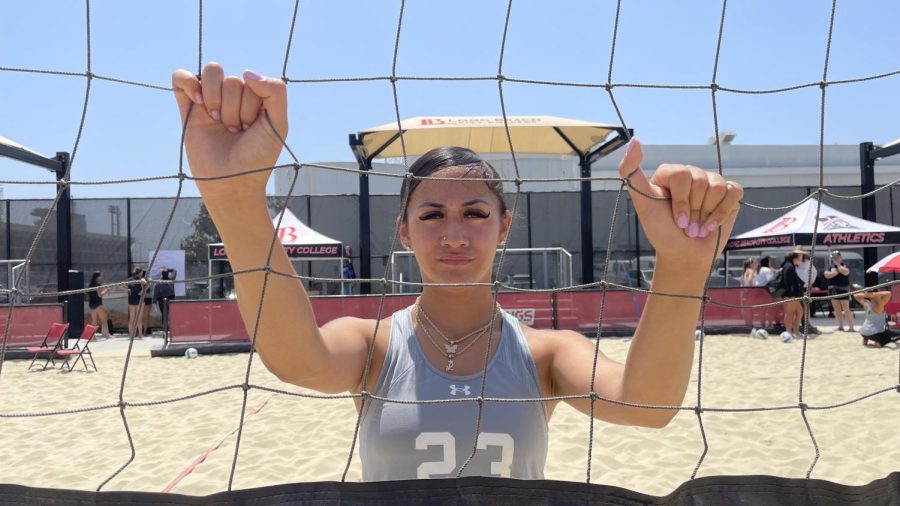 Volleyball player Leafa Juarez grabs the volleyball net at the Long Beach City College Beach Volleyball Complex on April 28. She said she prepares for each match by praying. (Ma. Gisela Ordenes | The Union)
