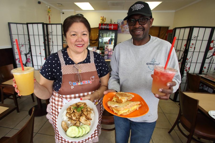 Sausalido Cafe owners Lucy Liampetchakul and Julius Obembe proudly present their menu, offering an array of delectable dishes and beverages. The restaurant is located at Redondo Beach Boulevard and Yukon Avenue. (Raphael Richardson | Warrior Life)