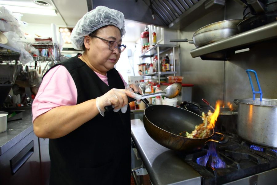 Kyong+Yu%2C+owner+of+the+Korean-themed+restaurant+Mr.+Hs+Lunch+Place%2C+tosses+a+wok+of+food+into+the+air+as+she+cooks+a+meal+for+her+workers+in+Gardena.+%28Raphael+Richardson+%7C+Warrior+Life%29