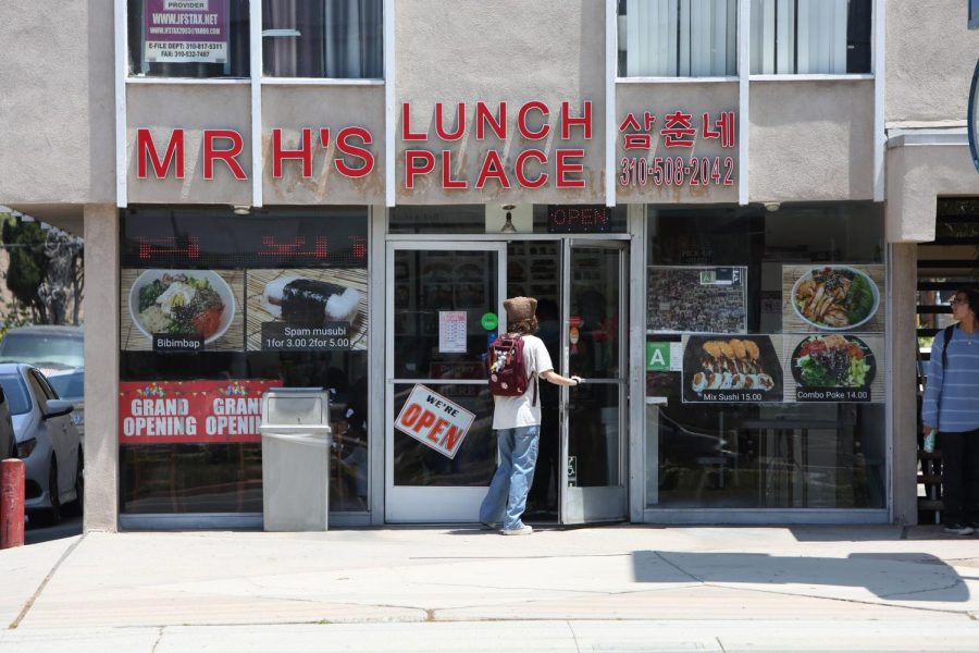 A customer enters Mr. H’s Lunch Place during the midday lunch rush. The label scar of Wasabi Sushiya’s old sign is visible behind the new blazing red sign of Mr. H’s. (Raphael Richardson | Warrior Life)