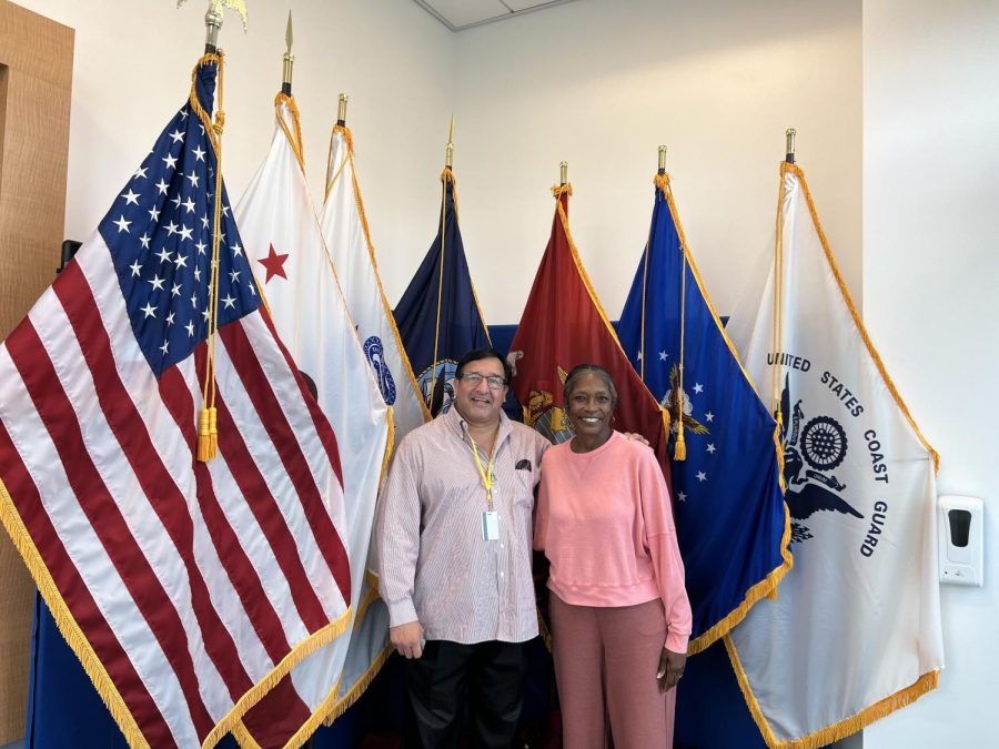Lawrence Moreno, overseer of the Veterans Services Resource Center, and El Camino College Assistant Director of Veterans Services Brenda Threatt stand with the flags of the United States armed services inside Veterans Services at ECC on Monday, April 11, 2022. (Safia Ahmed | Warrior Life)