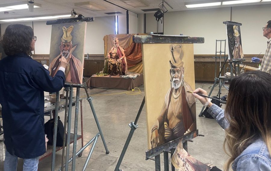 J.J. Cole (center) models in a life drawing class at El Camino College on April 4, as students Hyekyung Kim (left) and Fumie Coello (lower right) paint his portrait. Cole has worked as an art model for 25 years after retiring from a career as a professional dancer in Houston, New York City and Los Angeles. (Kim McGill | Warrior Life)