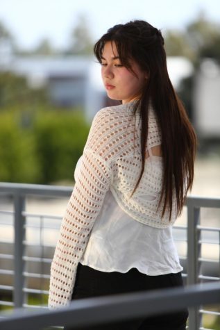 El Camino College neuroscience major Piper Takenaka wears a knitted sweater from Yesstyle, an Asian beauty and fashion retailer which is improvised into a cardigan that accompanies a lacy camisole top and black jeans. (Raphael Richardson | Warrior Life)
