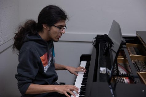 Theatre arts major Kenneth Castro sings and plays ballad covers of pop songs in the Music Building on May 31. Castro said hes been playing on-and-off for five years and uses the Music Buildings practice rooms to strengthen his skills. (Khoury Williams | The Union)