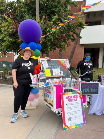 Faculty and outreach librarian Camilla Jenkin poses next to the book on Thursday, June 1, at the student services plaza. The on-the-go resource reflects a collection of books based on the event and information for students.