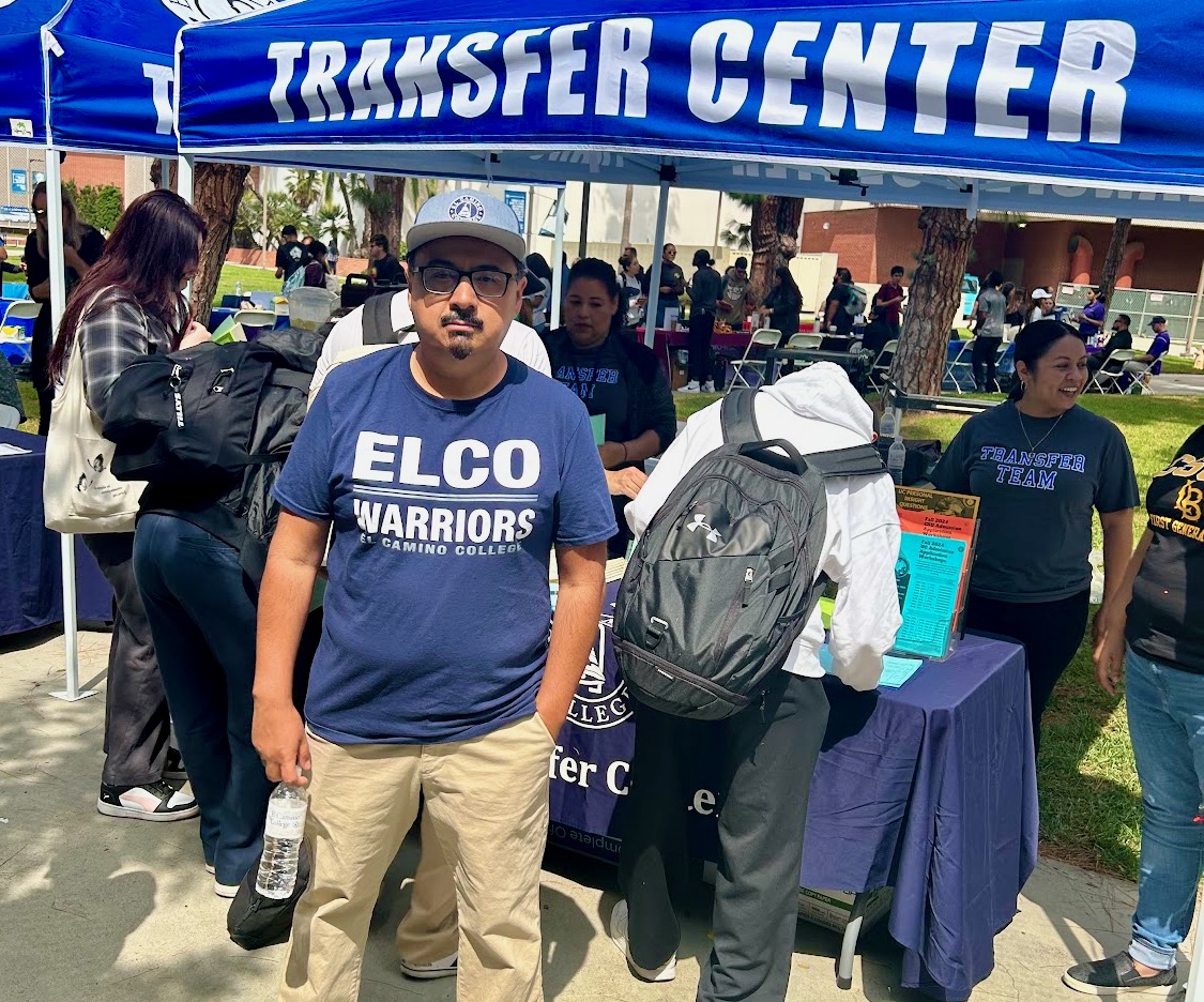 El Camino College Transfer Admissions Coordinator Rene Lozano poses in front of the Transfer Center booth during the Fall University Transfer Fair on Thursday, Sept. 21, 2023. (Nellie Eloizard | The Union)