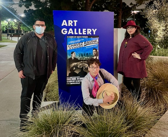 Campus Senator of Fine Arts Dulce Stein and students Chris Hernandez and Patrick Hahn pose in front of the poster advertising the screening of “Chavez Ravine: In 9 Innings” hosted inside the new Arts Complex on Saturday, Sep. 16. (Alondra Camarena | The Union)