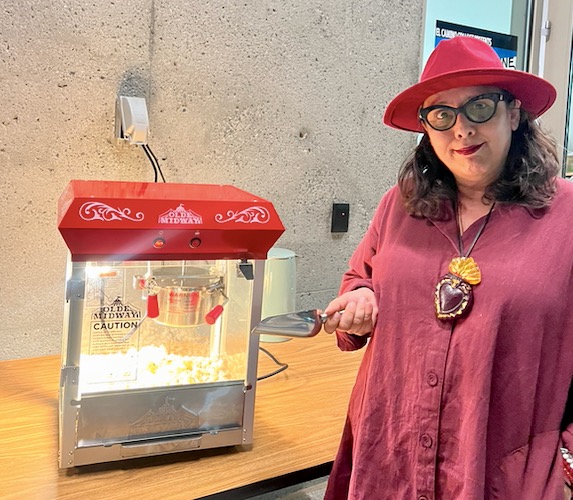 El Camino College Senator of Fine Arts Dulce Stein poses with a popcorn machine after the screening of “Chavez Ravine: In 9 Innings” inside the El Camino College Art Gallery at the new Arts Complex on Saturday, Sept. 16. (Alondra Camarena | The Union)