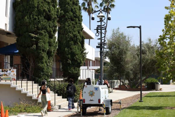Students walk past a surveillance tower set up by the El Camino College Police Department and placed behind the Communications Building on Wednesday, Sept. 13, 2023. (Photo by Raphael Richardson | The Union)