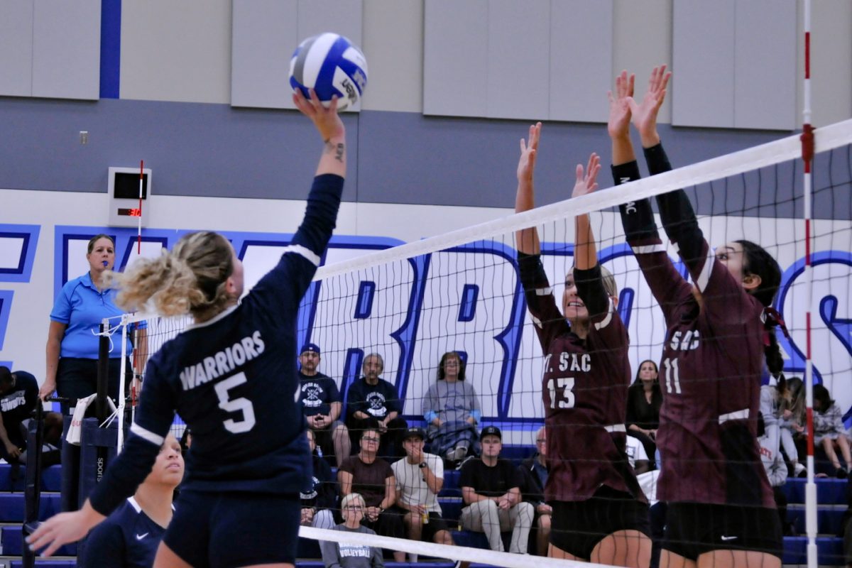 Outside Hitter Ryan DAngelo tips the ball over the Mt. Antonio blockers in a womens volleyball game at the South Gym during the Wednesday, Sept. 20 game at El Camino College. (Ira Mendoza | The Union)