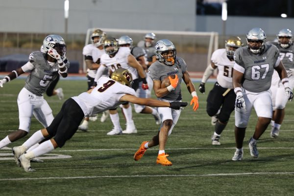 Desperate attempts by Southwestern failed to stop El Camino running back Marceese Yetts during Yetts's 52-yard sprint to the end zone at Featherstone Field on Saturday, Sept. 2, 2023. (Saqib Rawda | The Union)