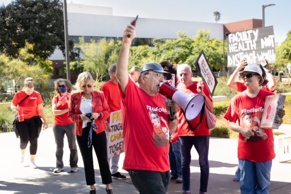 Art History Professor Ali Ahmadpour leads The El Camino College Federation of Teachers as they march through the campus to protest ongoing contract issues with the college district on Sept. 6. (Khoury Williams | the Union)