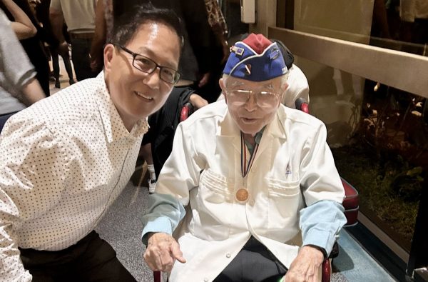 Yoshio Nakamura, 98, poses for a photo with his Whittier neighbor who drove him to El Camino College on Saturday, Sept. 9., to attend a presentation of “Defining Courage.” The mixed media immersive show honors the sacrifice of the Nisei soldier who fought in World War II. Nakamura is a former Nisei soldier. (Nellie Eloizard | The Union)