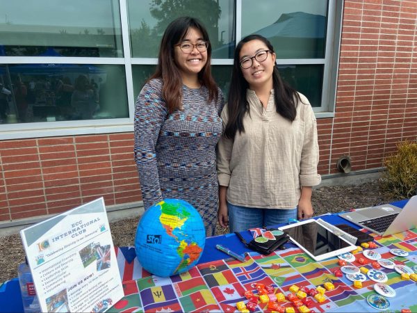 Mary Calingasan, Director of International Club, poses by her table at Club Rush on Wednesday morning, alongside the vice president of the club.