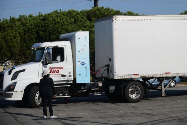 An instructor teaches a student how to drive a semi truck in a blocked off portion of Lot L at El Camino College on Monday, Oct. 2, 2023. (Lana Mily | The Union)