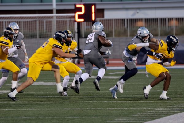 El Camino running back Amani Givens rushes past College of the Canyons players during a home game at El Camino College on Thursday, Oct. 12. (Bryan Sanchez | The Union)