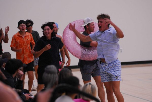 El Camino fans, dressed up for the beach, try to hype up the crowd during a women's volleyball home game against Long Beach on Friday, Oct. 13. (Osvin Suazo | The Union)