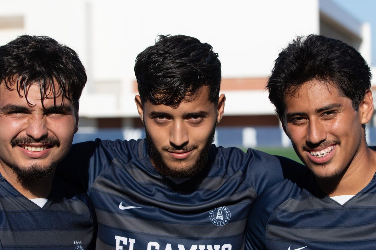 El Camino forward Jovanny Mejia,  middle, with teammates Orlando Valencia-Jimenez, left, and Franco De Luna, take a group photo after the teams 8-0 win during the Oct.17 match against Compton College. Mejia and El Camino womens soccer player Yoseline Panduro both earned the National Player of the Week award as determined by the United Soccer Coaches. (Renzo Arnazzi | The Union)