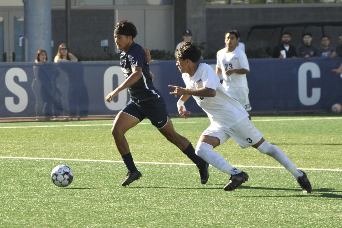 El Camino forward Shingo Nakano out paces an LA Harbor College player to reach the goal during a mens soccer game on Oct. 20. (Ira Mendoza | The Union)