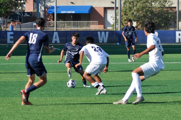 El Camino midfielder Issac Machuca dribbles his way around a Los Angeles Harbor College defender during a men's soccer game on Oct. 20. (Ira Mendoza | The Union)