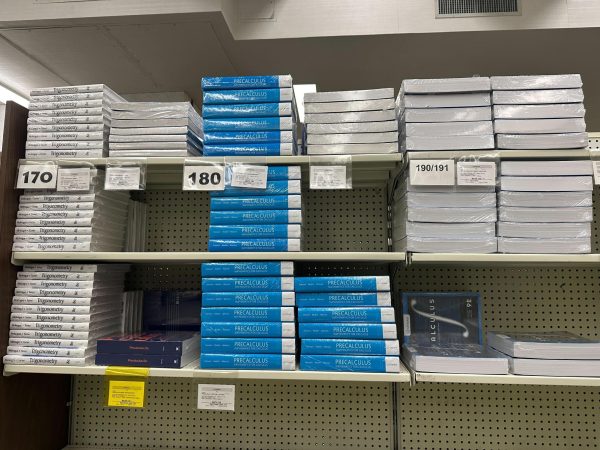 Stacks of math textbooks currently on sale inside the El Camino College Bookstore on Oct. 18. Books are priced differently, a precalculus work book is $50 while the precalculus textbook is over $200. (Nick Geltz | The Union)