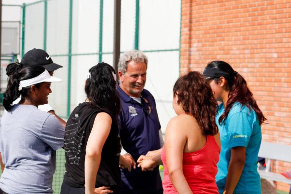 Sergiu Boerica and the El Camino women's tennis pool of players huddle after practice at the ECC Tennis Courts on Wednesday, Sept. 27. (Monroe Morrow | The Union)