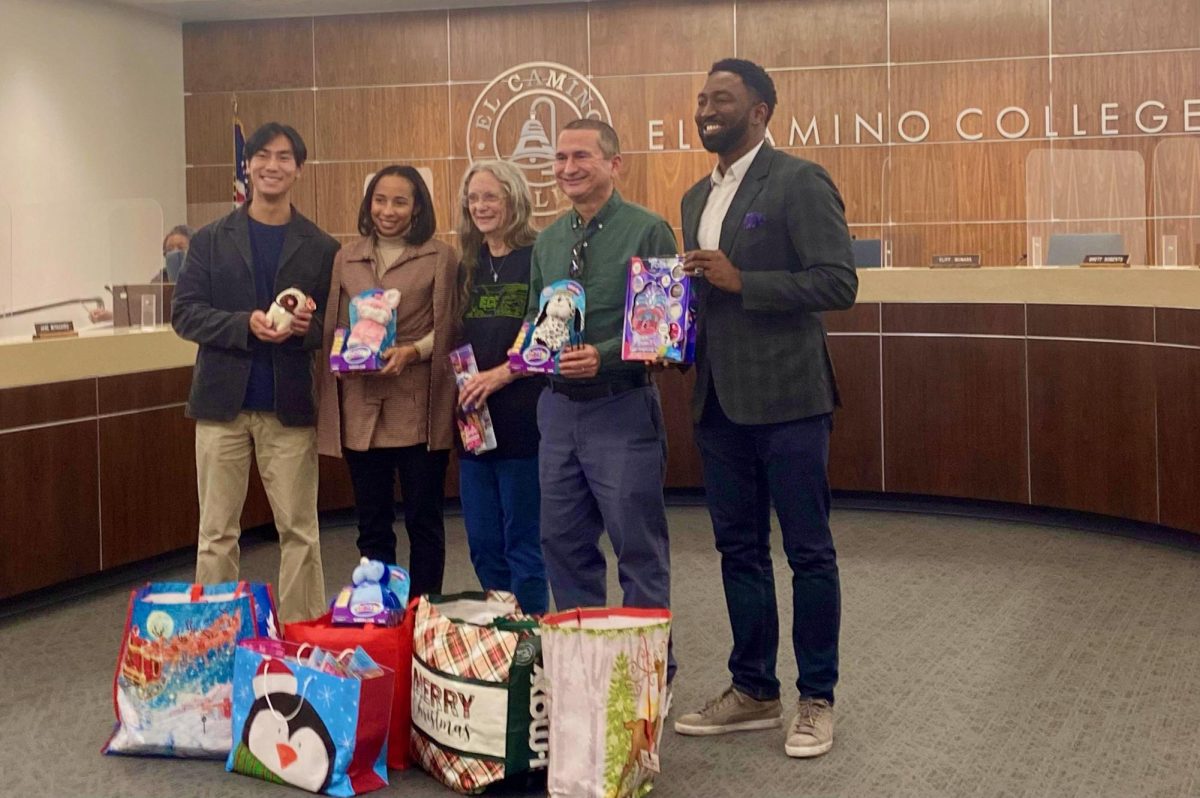 Board of Trustee Katherine Maschler, center, presents her donated toys along with student trustee Connor Lai, left, associate director of EOPS, CARE and CalWORKS Kristen Johnson, Trustee Nilo Michelin and Trustee Brett Roberts on Monday, Nov. 20. (Angela Osorio | The Union)