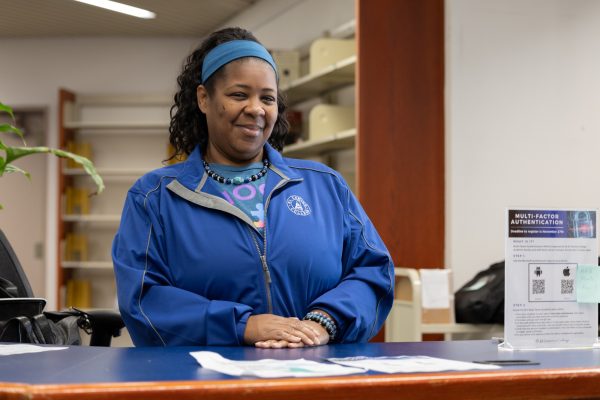 Library and learning resources specialist Erika Yates, wearing a jacket to keep warm, mans the front desk at the Schauerman Library on Thursday, Nov. 16. (Raphael Richardson | The Union)