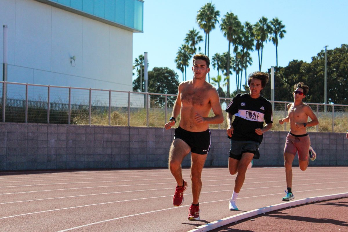 Running an interval workout, Aaron Cohen trains with his teammates Alan Canales (middle), and Ty McCormick (Right) at El Caminos track on Nov. 1. (Saqib Rawda | The Union) Photo credit: Saqib Rawda