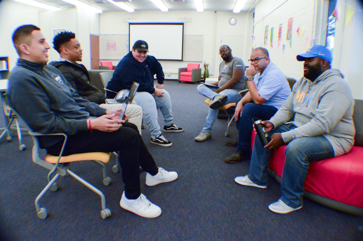 Men of Color Action Network members discuss how they can assist students and help them reach their educational and life goals in the Social Justice Center on Wednesday, Nov. 8. (Clarence Davis | The Union)